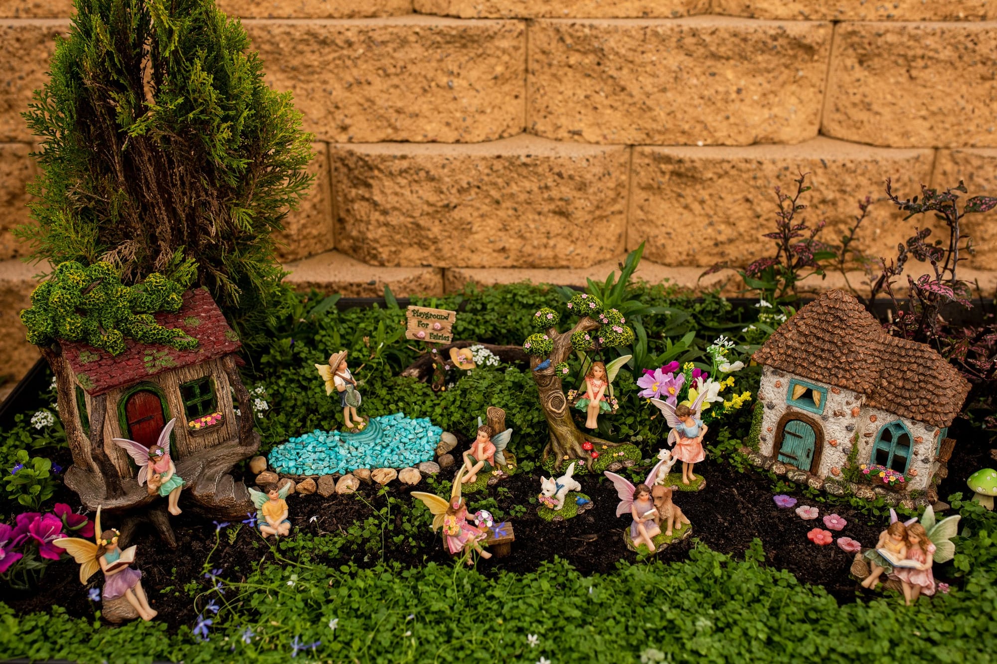 fairy-themed bottle garden with figurines