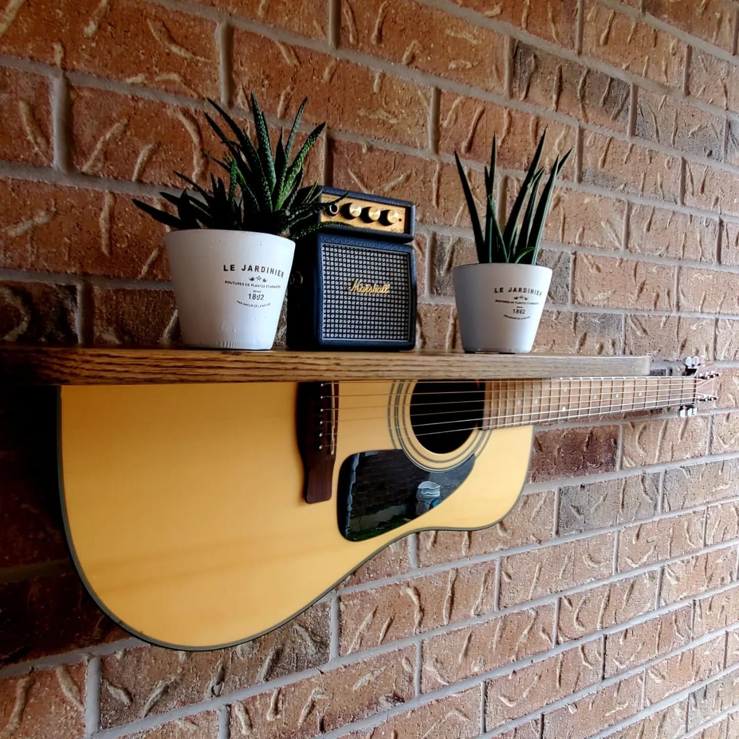 hanging guitar planter on patio wall