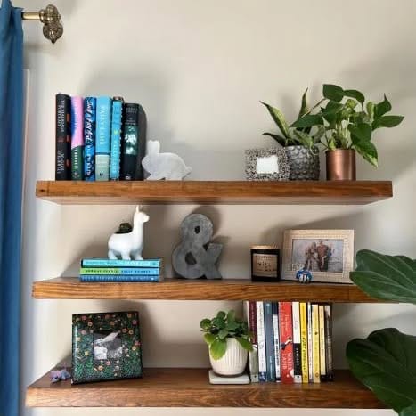 floating shelves on reclaimed wood wall