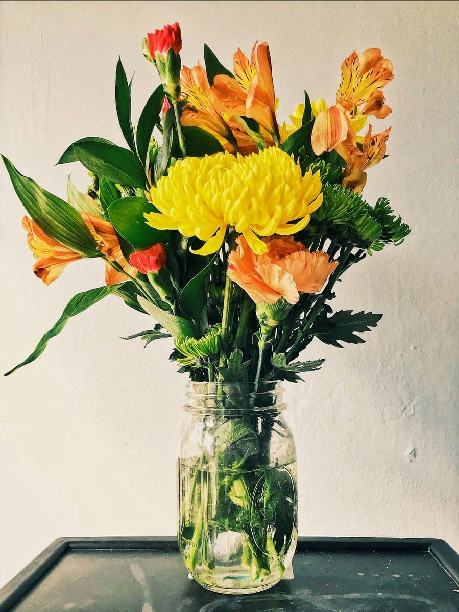 Table centerpiece with vinyl record plant pot stand and seasonal blooms