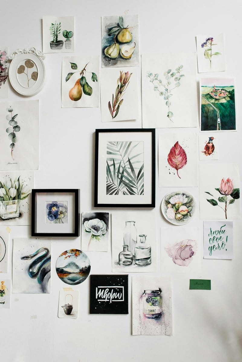Abstract watercolor art behind eclectic plant arrangement