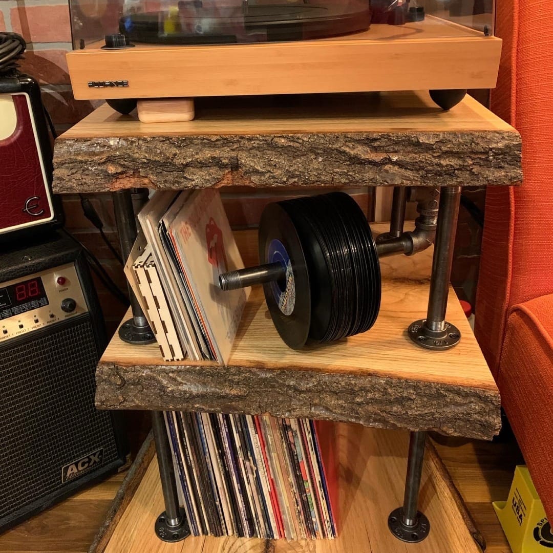 industrial pipe shelving with plants and records