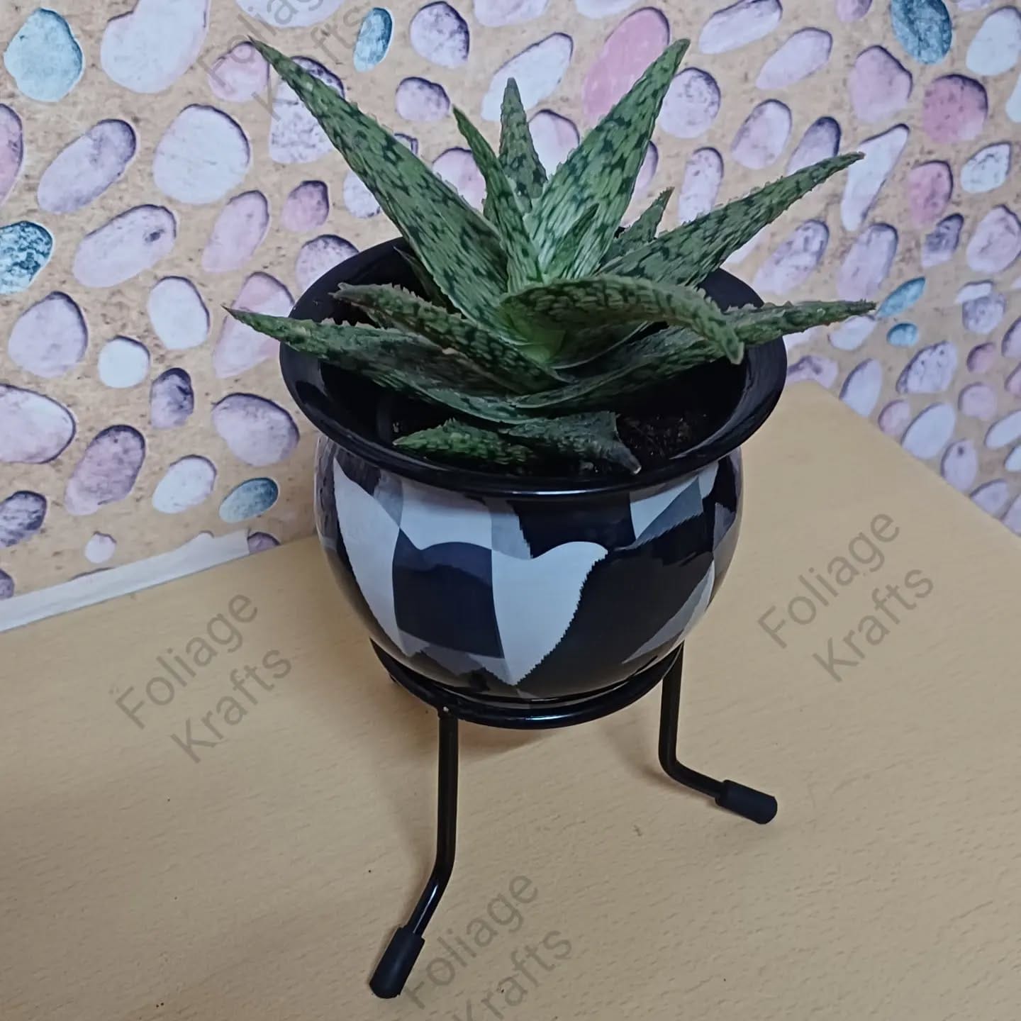 metal pot with tribal engravings holding ferns