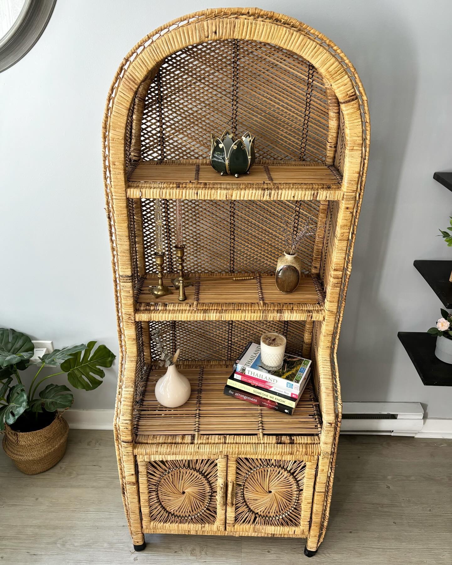 Bohemian-style rattan shelf with vintage decor and plants