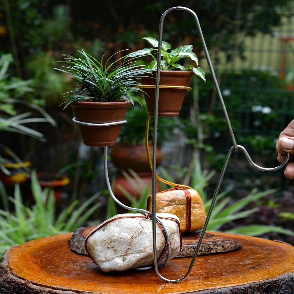 Terracotta pots on wrought iron stand