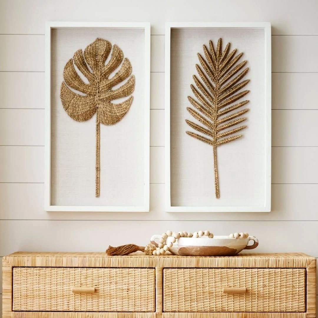 framed leaf art against a wall