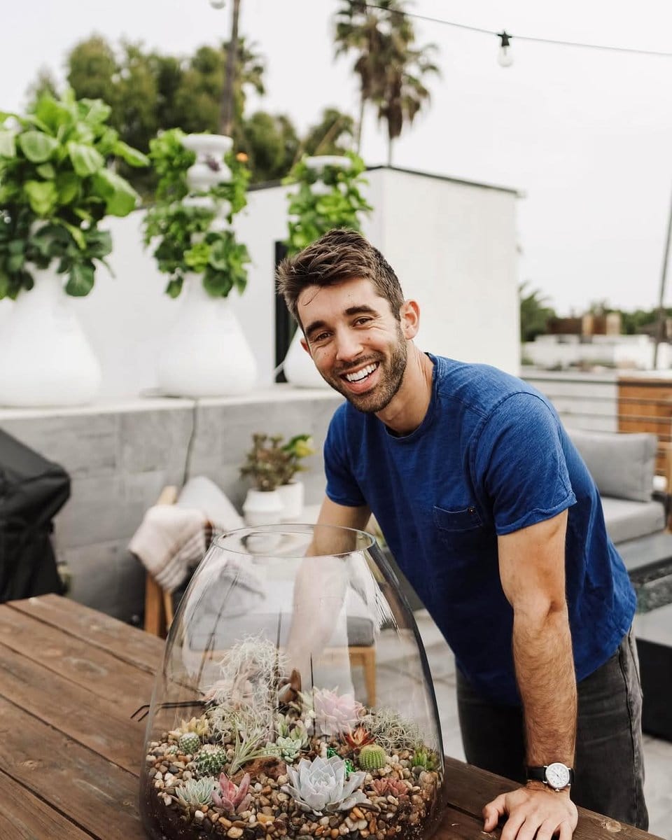 person relaxing near terrarium