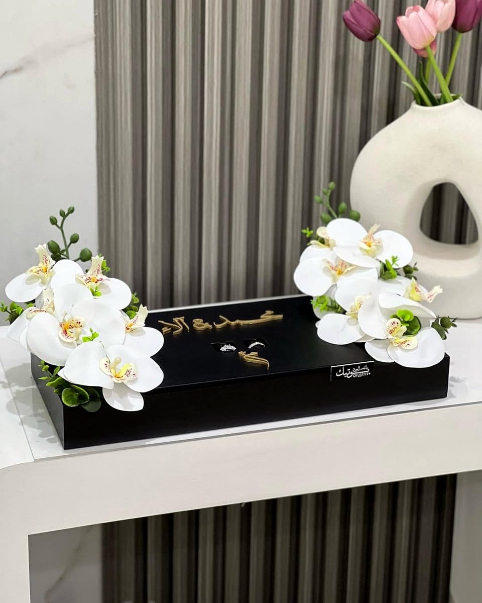 black tray with white orchids