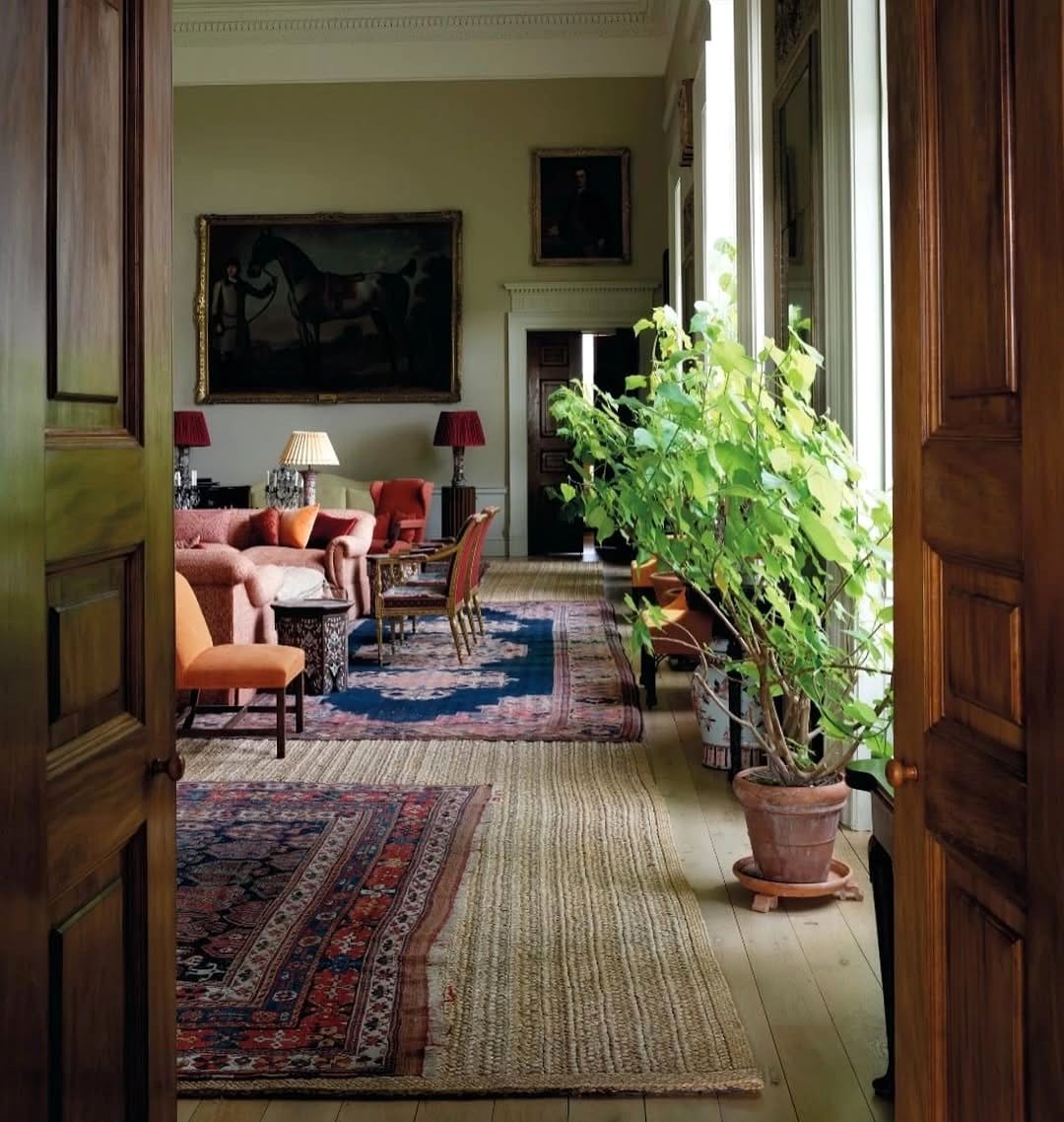Layered area rugs in rustic living room