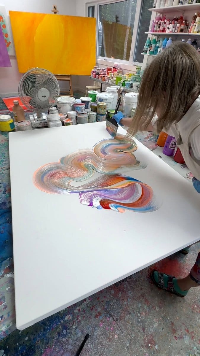 artist studio with rainbows on canvas