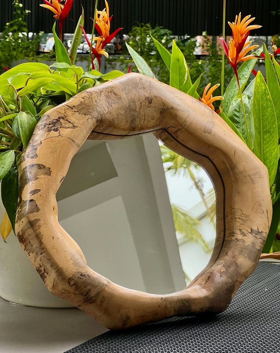 round mirror reflecting plants