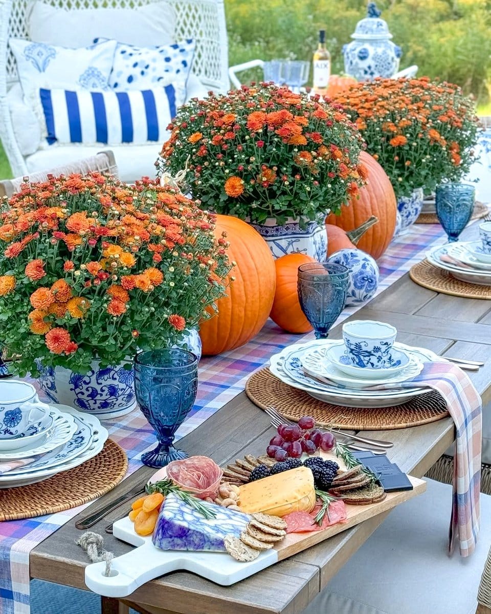 autumn-themed side table with pumpkins and mums