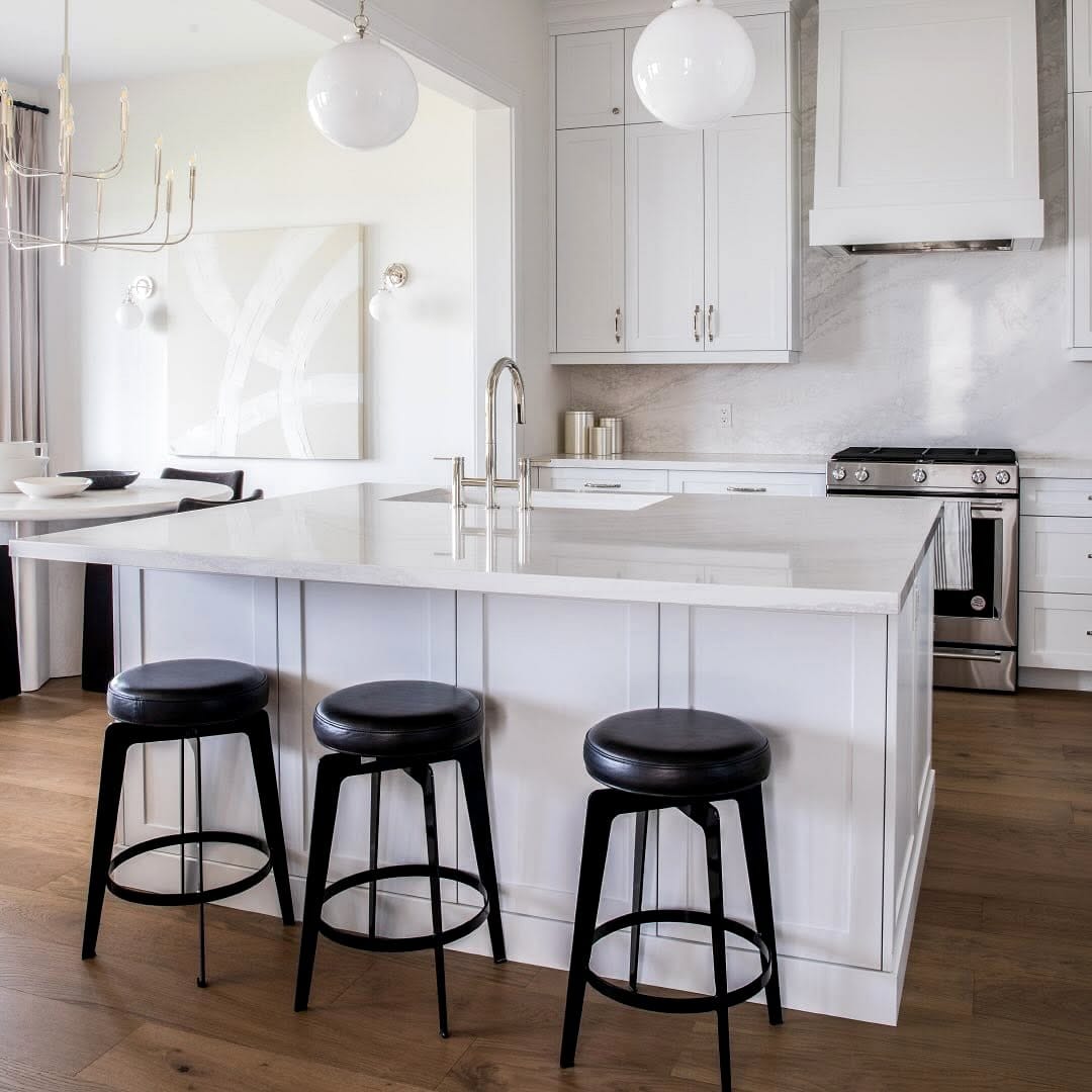 Sleek multipurpose kitchen island with bar stools