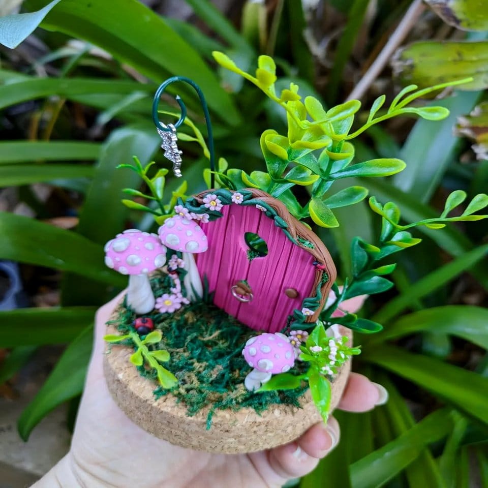 Whimsical indoor fairy garden with colorful figurines