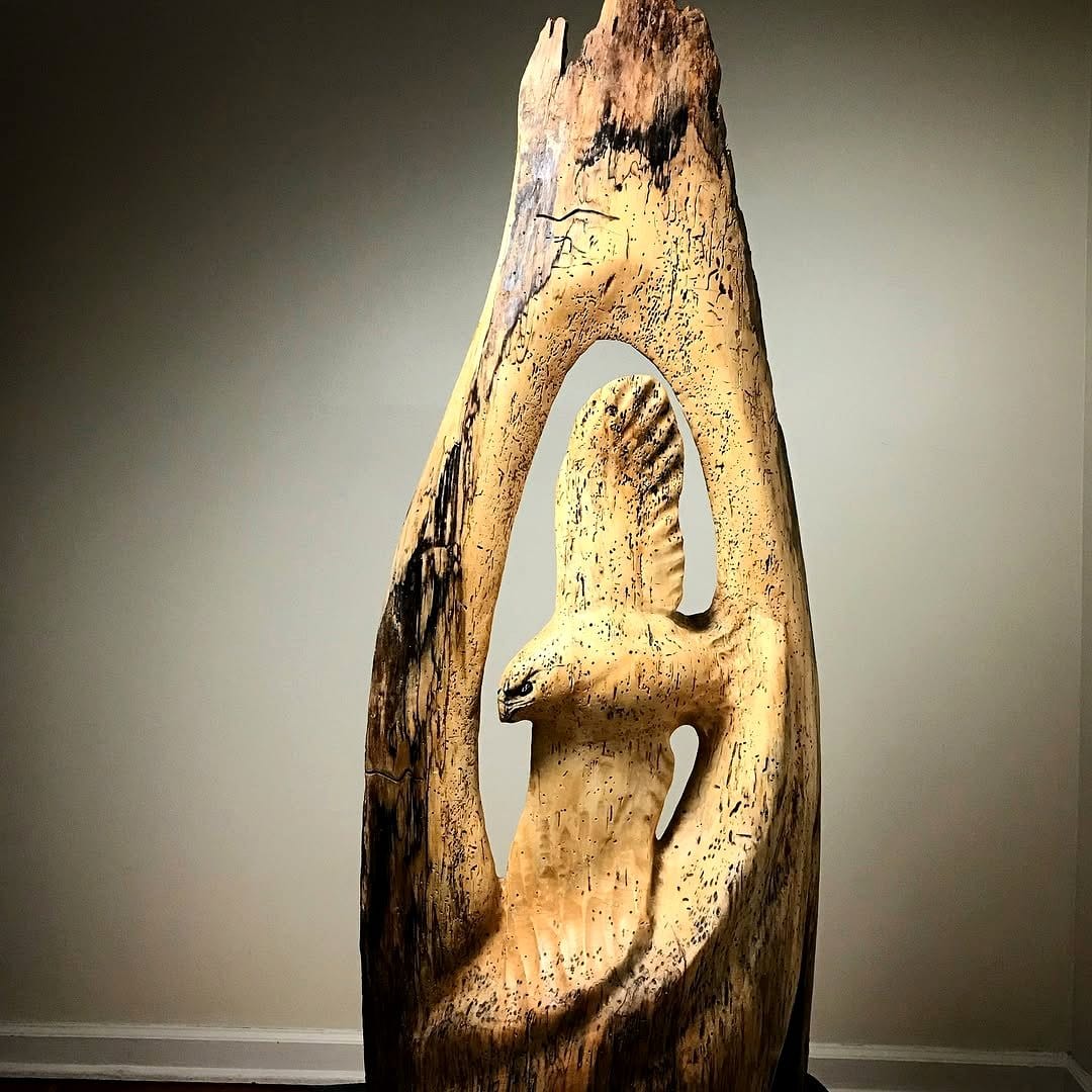 hollowed log sculpture on mantel