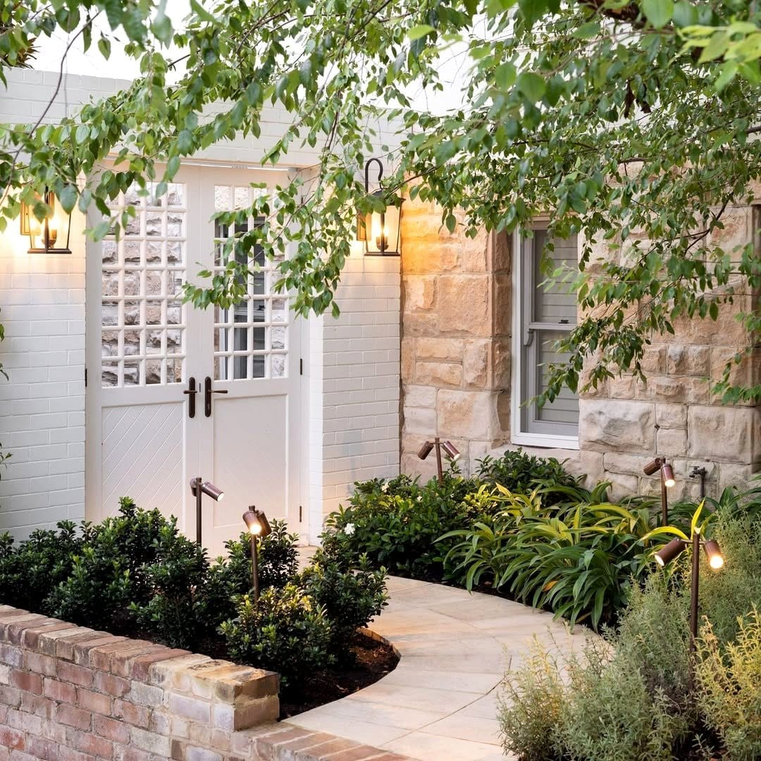 Plant uplighting near exposed brick wall