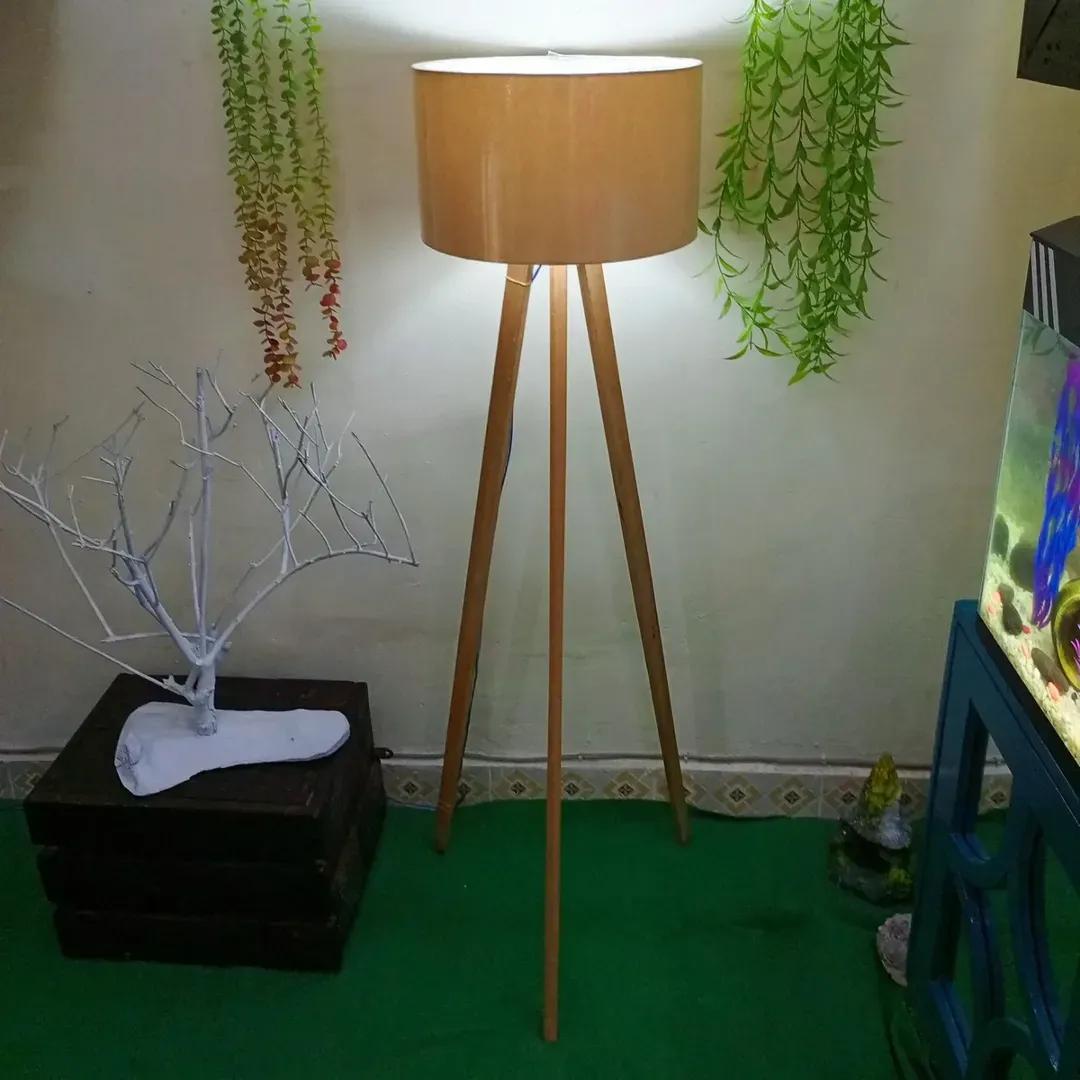 floor lamp with grow bulb next to plant