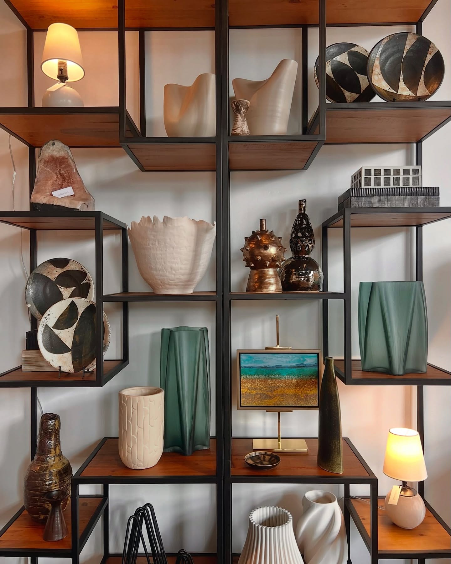 off-balance bookshelf with various books