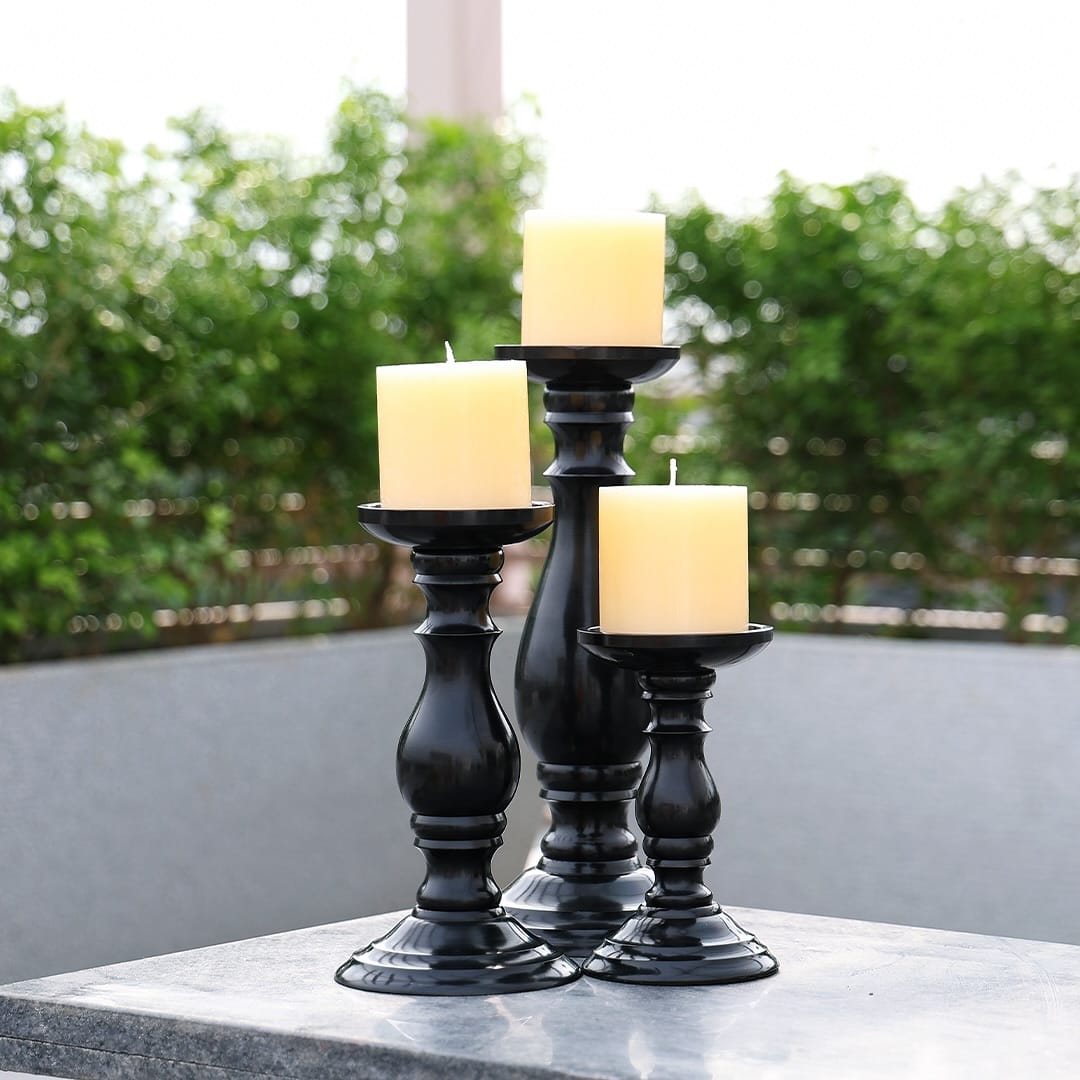 Wrought iron stand with candles and plants at night