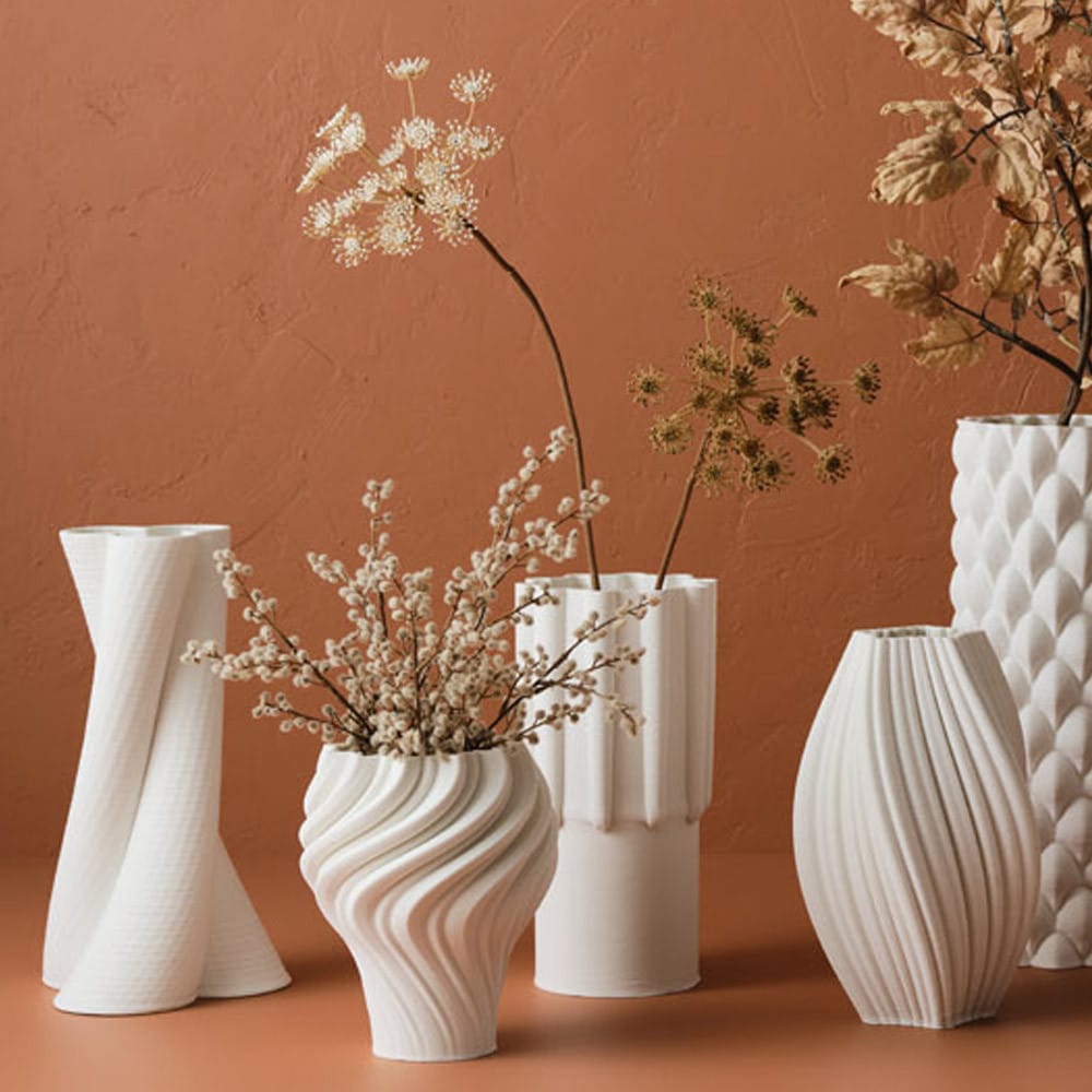 off-center pottery vase with single flower