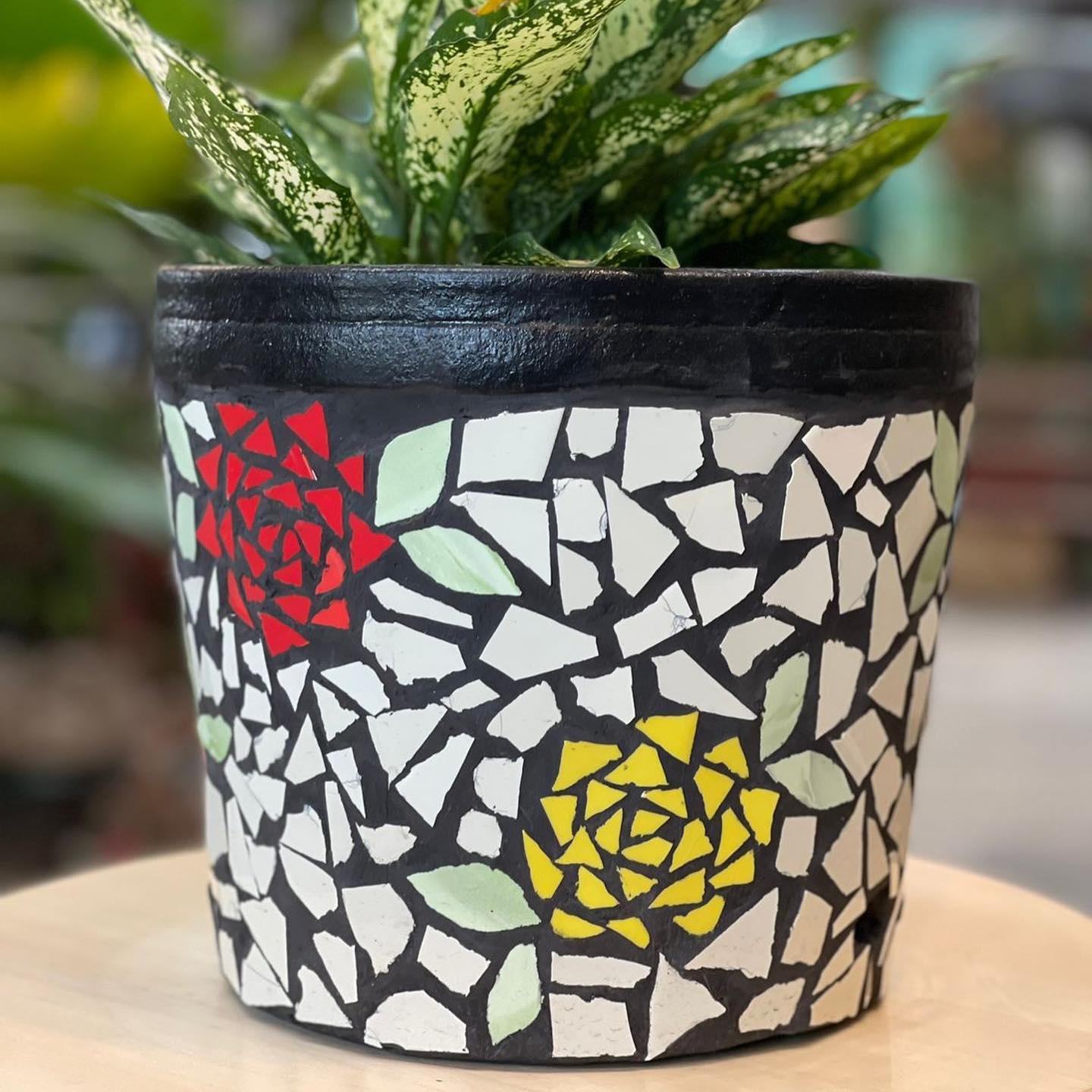 Mosaic-patterned plant pots in soft hues