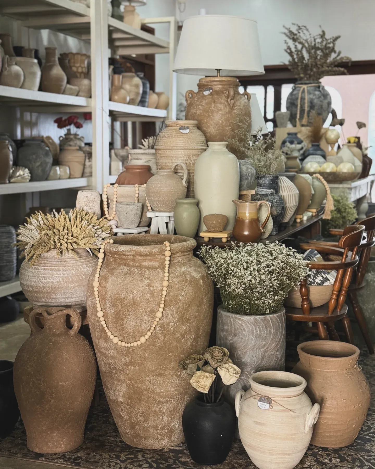 Handcrafted pottery collection on rustic shelves