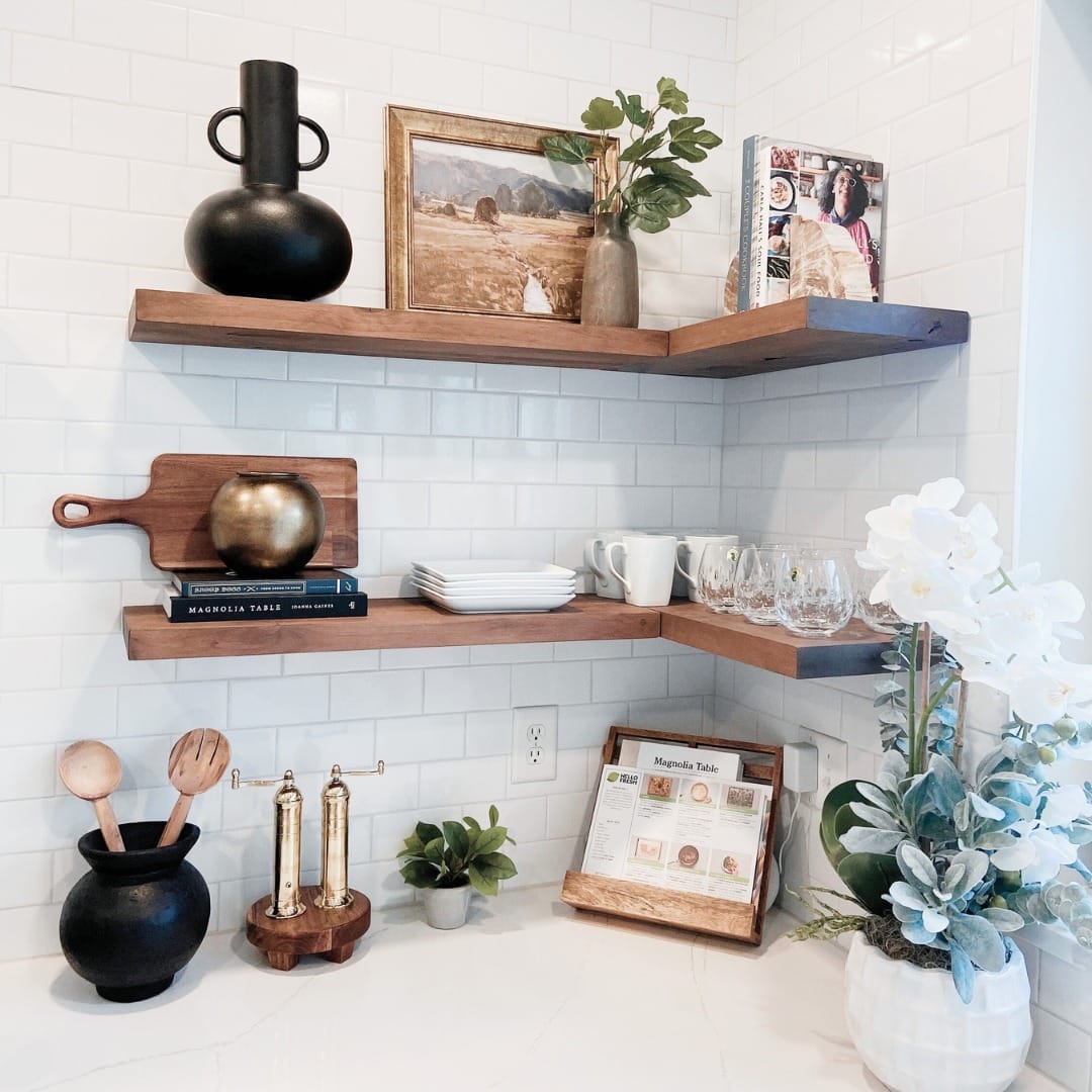 Whitewashed wooden shelves with lush green plants