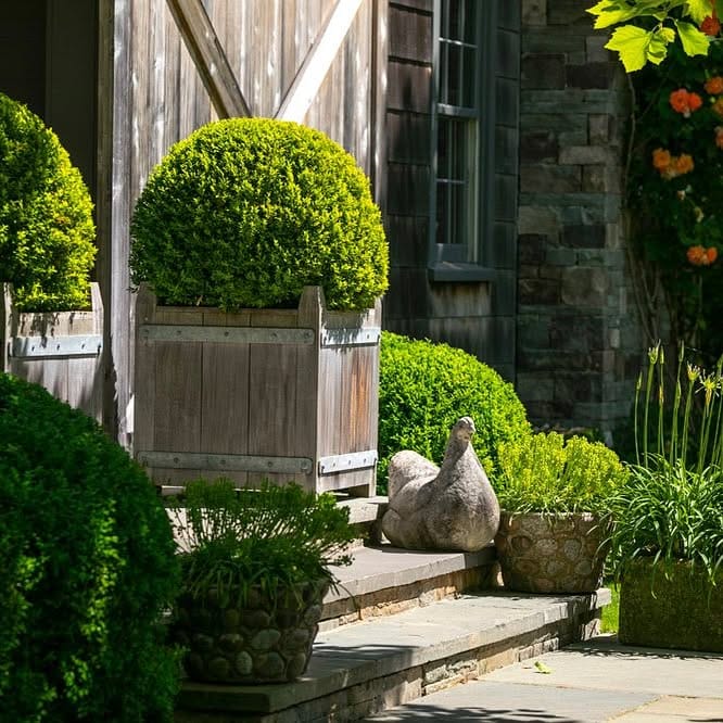 stone and wood planter in traditional garden