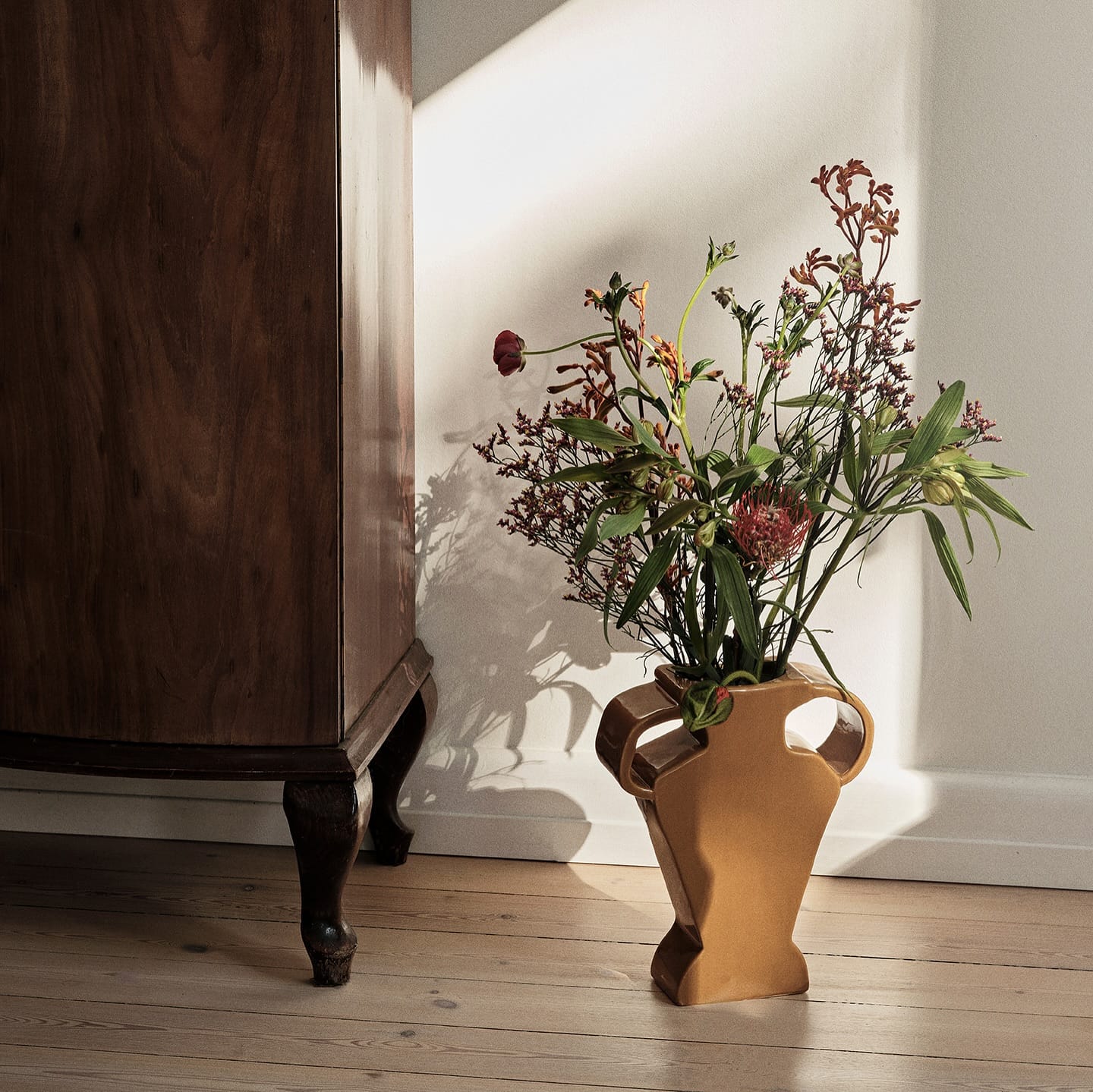 wooden sculptural vase with dried flowers