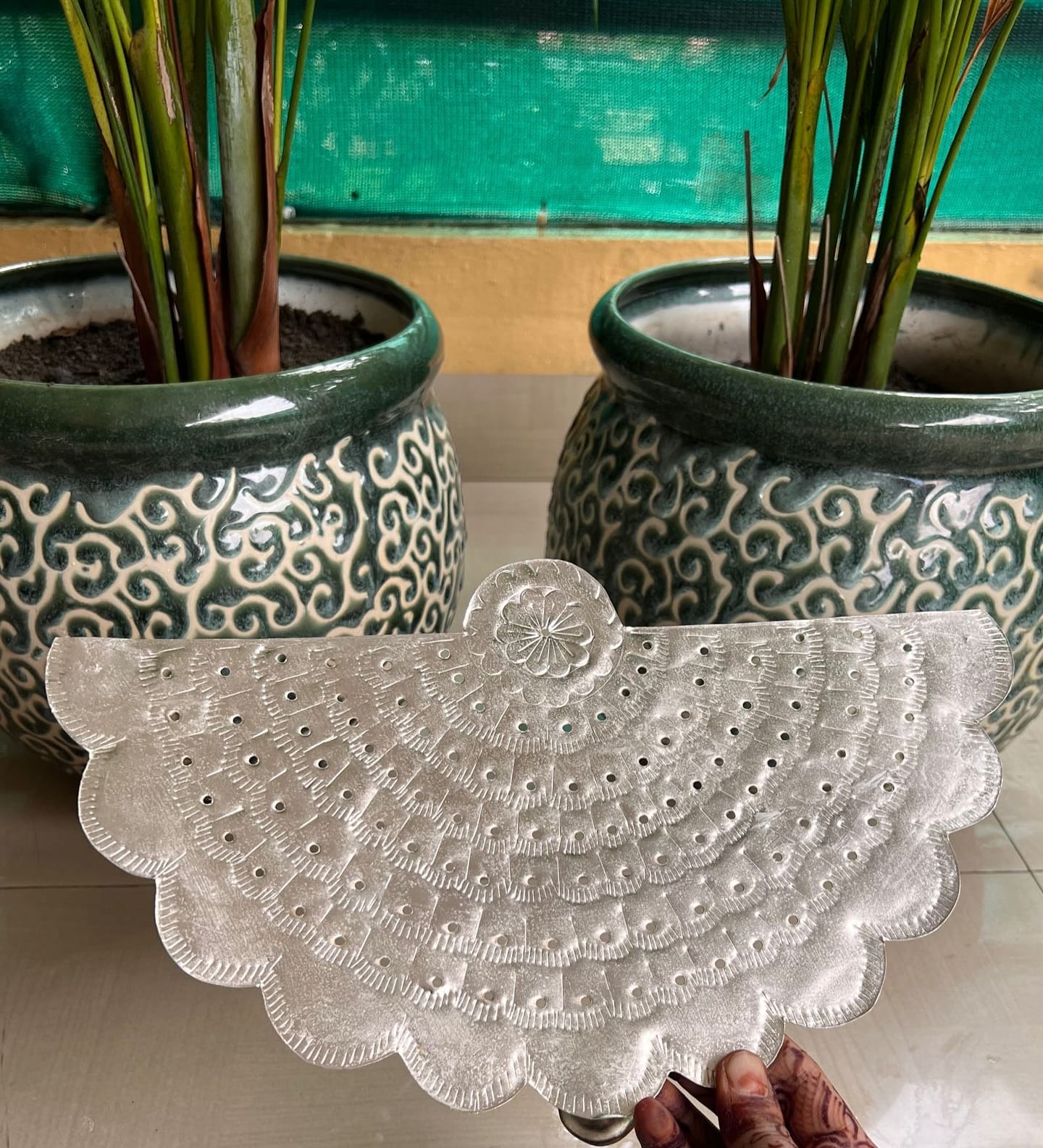 Delicate lace doilies under potted plants