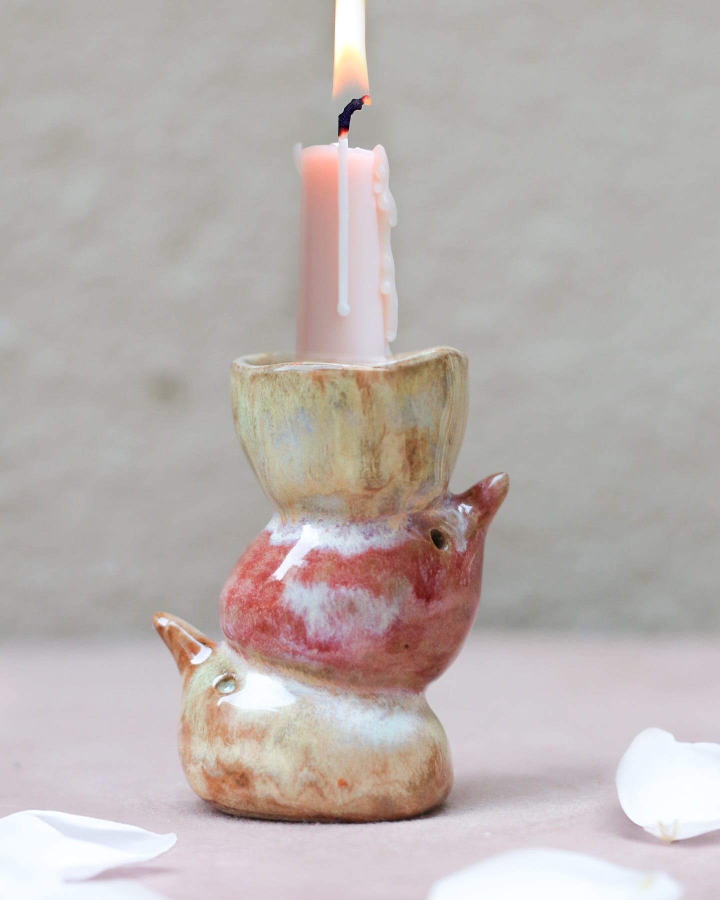 ceramic candle holder with lit candle