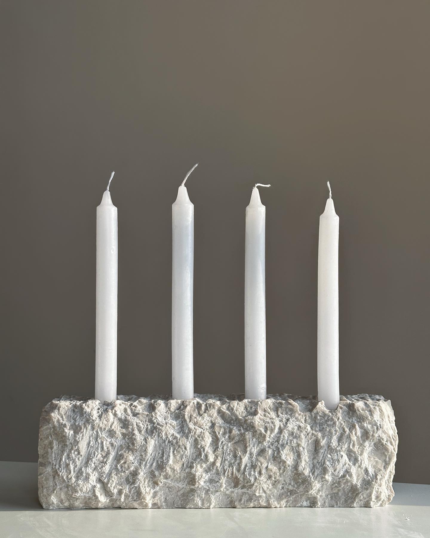 sandstone candle holders on mantelpiece