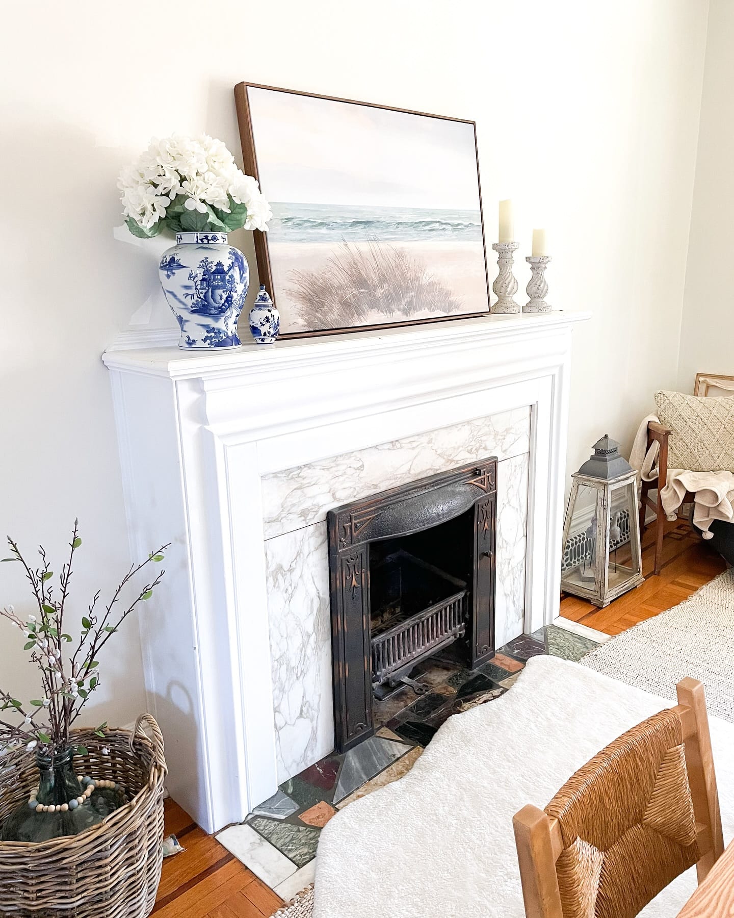 marble-look planter with orchids on mantel