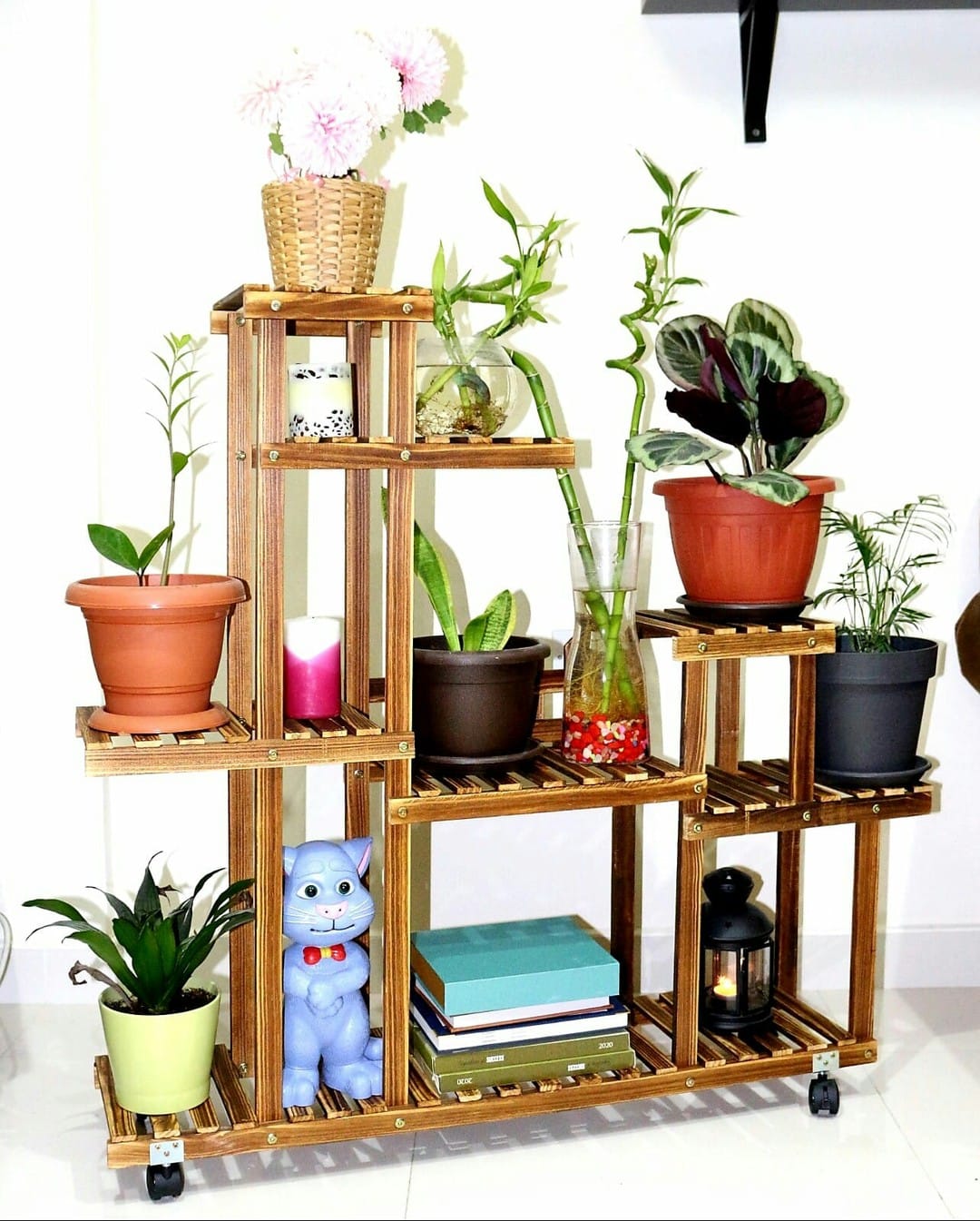 Rustic reclaimed wood plant stand with potted ferns