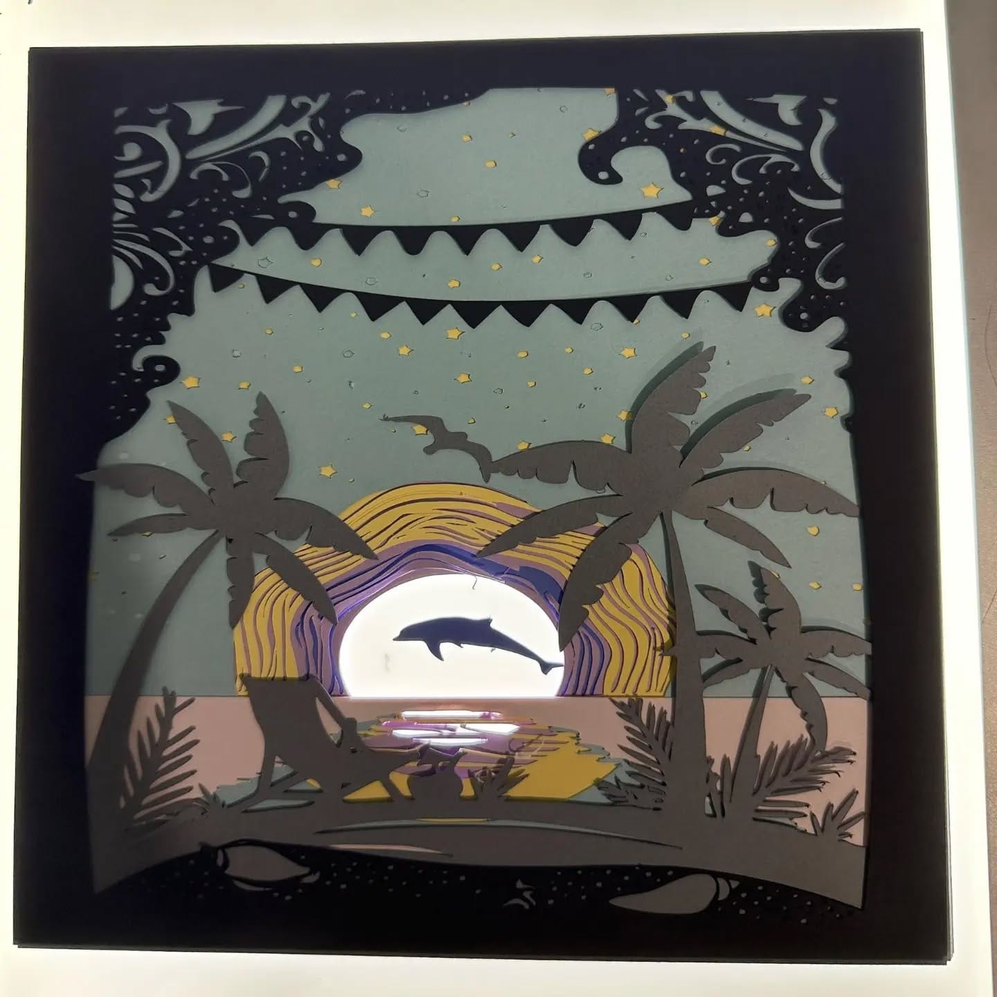 paper cutouts creating shadow art