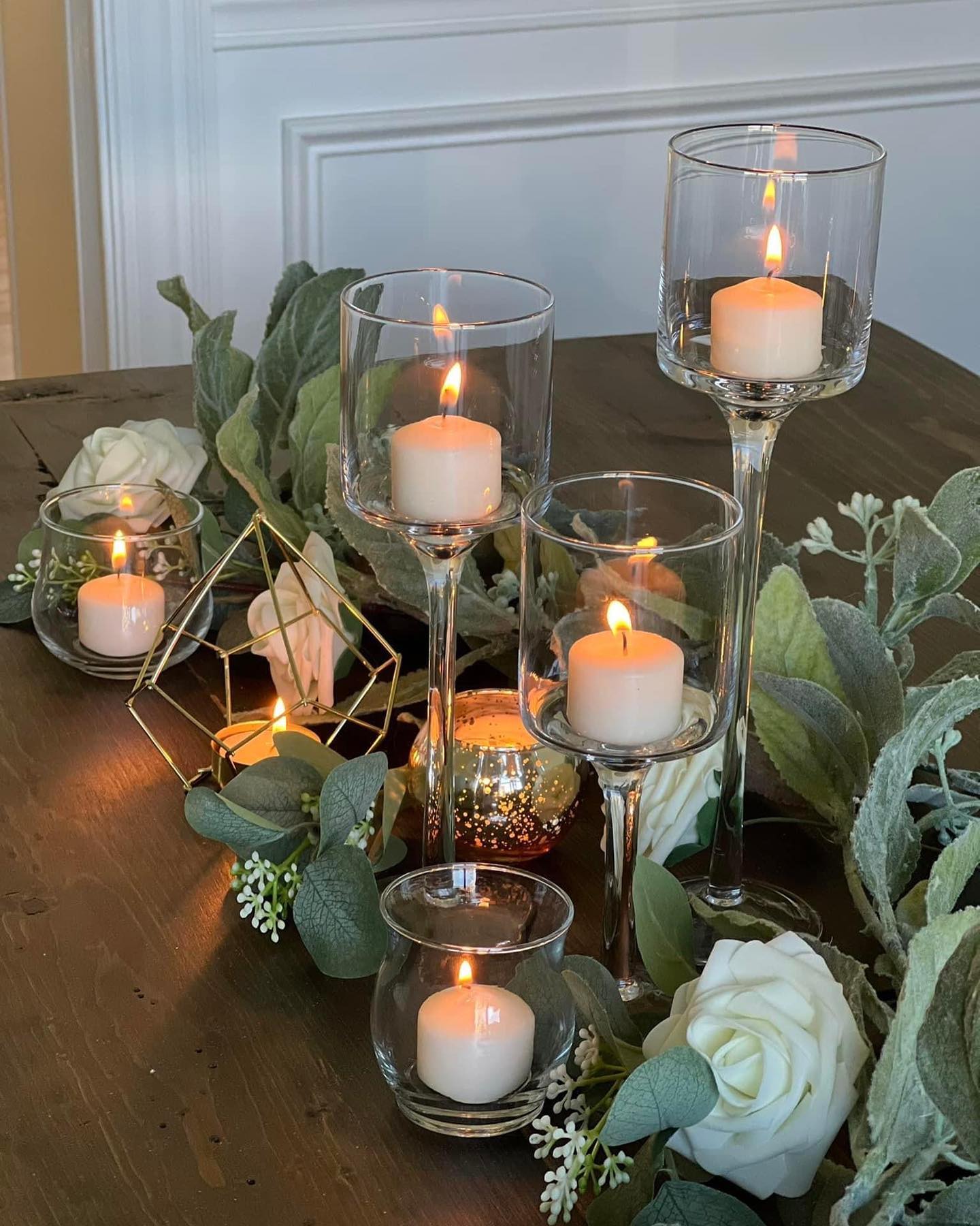 Glass terrarium with candles and rose petals