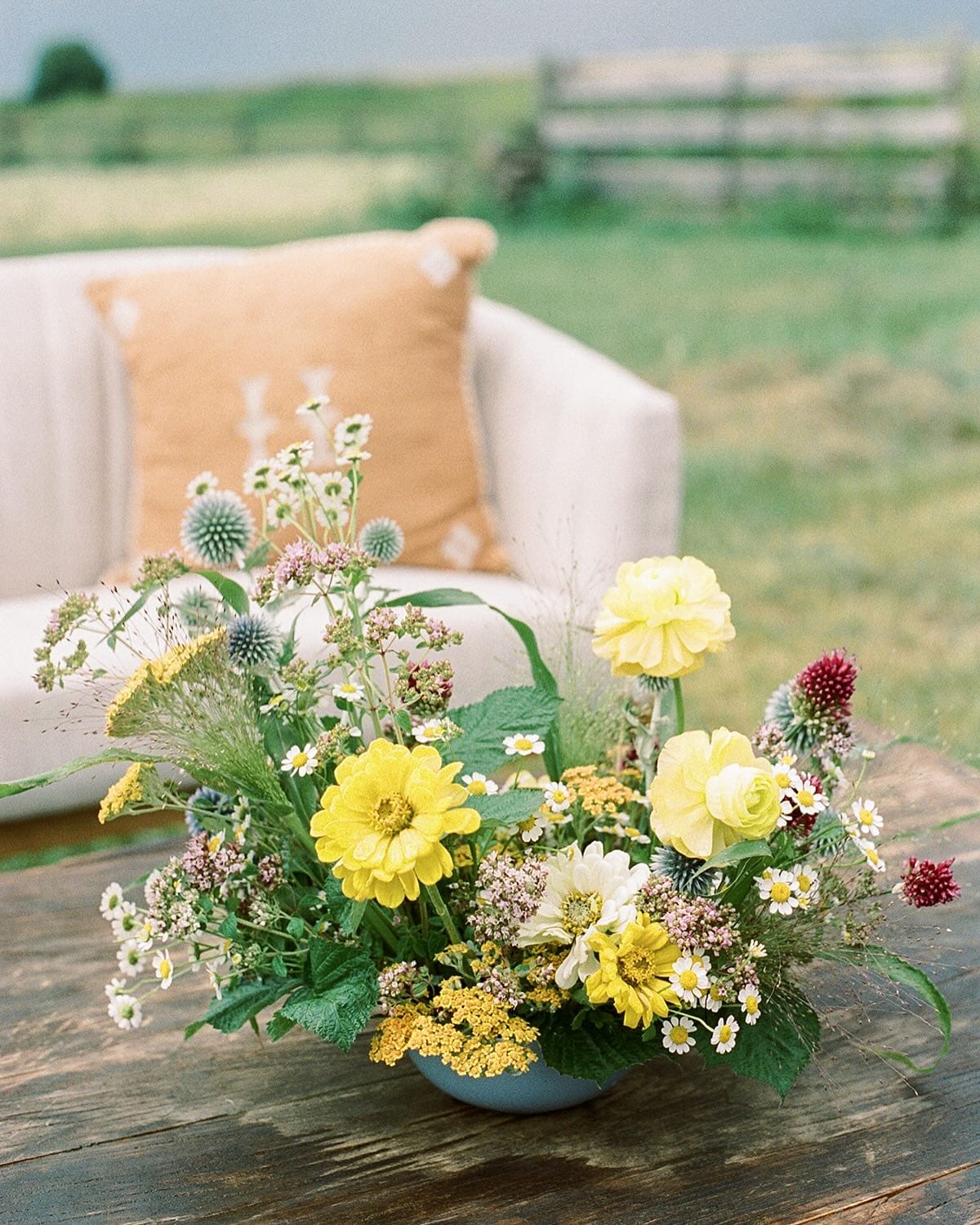 Colorful wildflowers in rustic wooden barrel